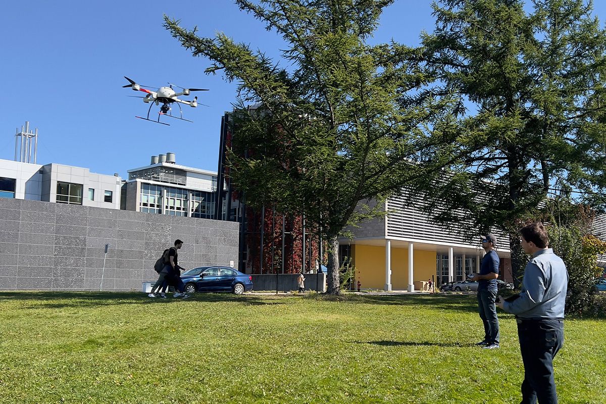 Étudiant faisant voler un drone dehors en été