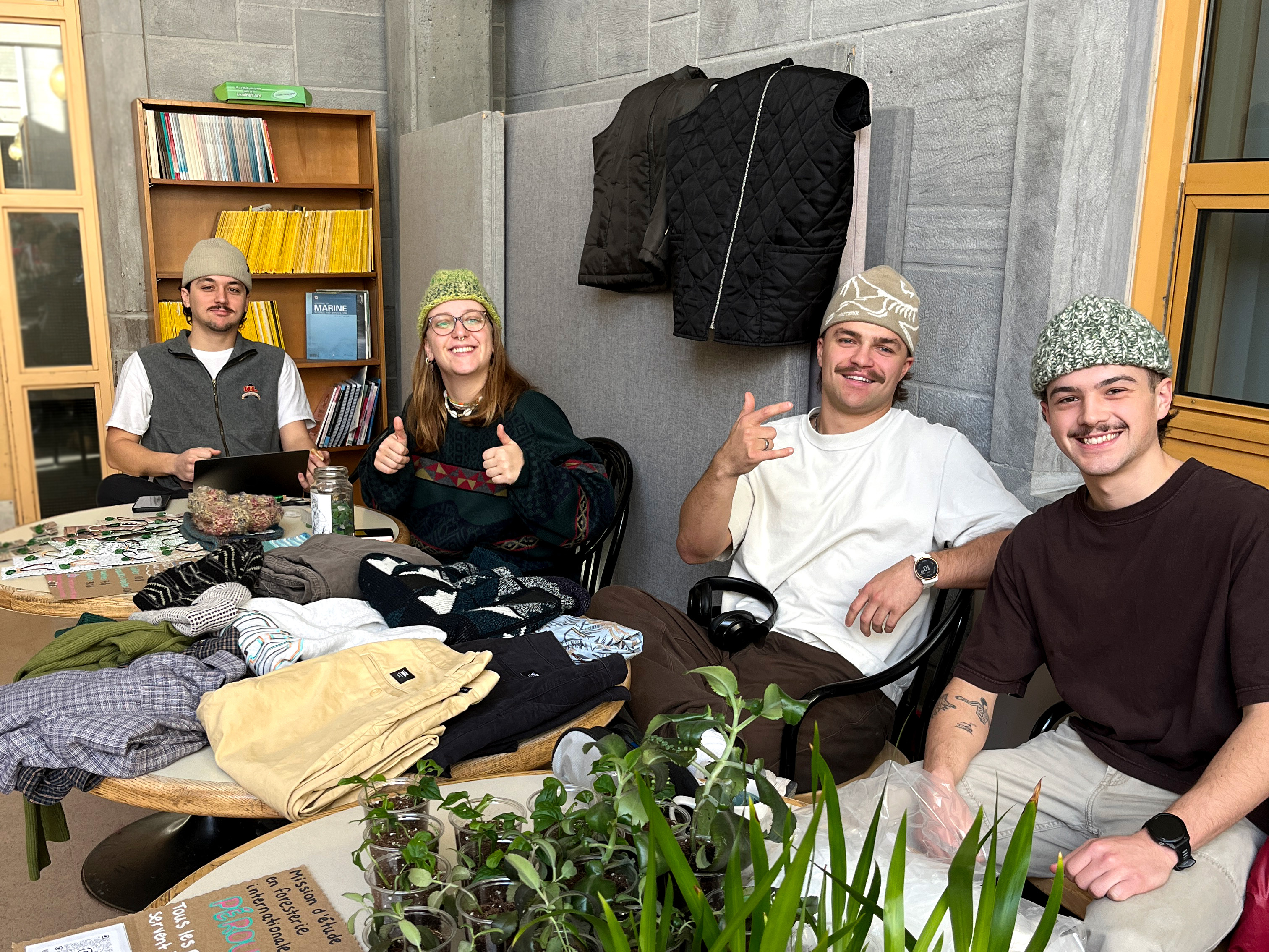 Quatre étudiants assis autour d'une table pour vendre des items